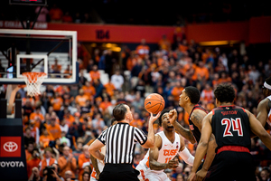 Syracuse and Louisville go up for the opening tip.